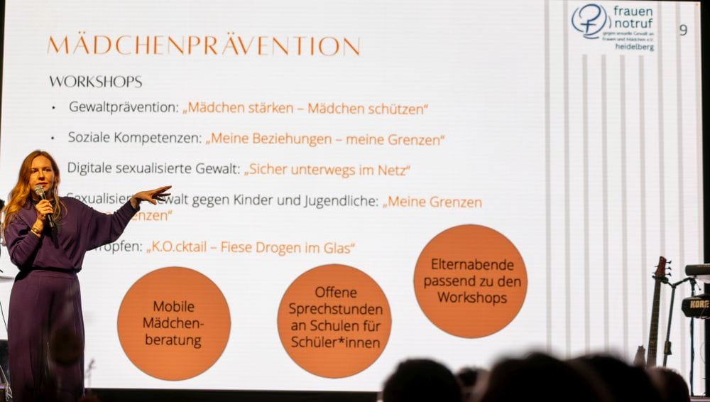 Frau vor einer Powerpoint-Folie zur Mädchenprävention des Frauennotruf Heidelberg